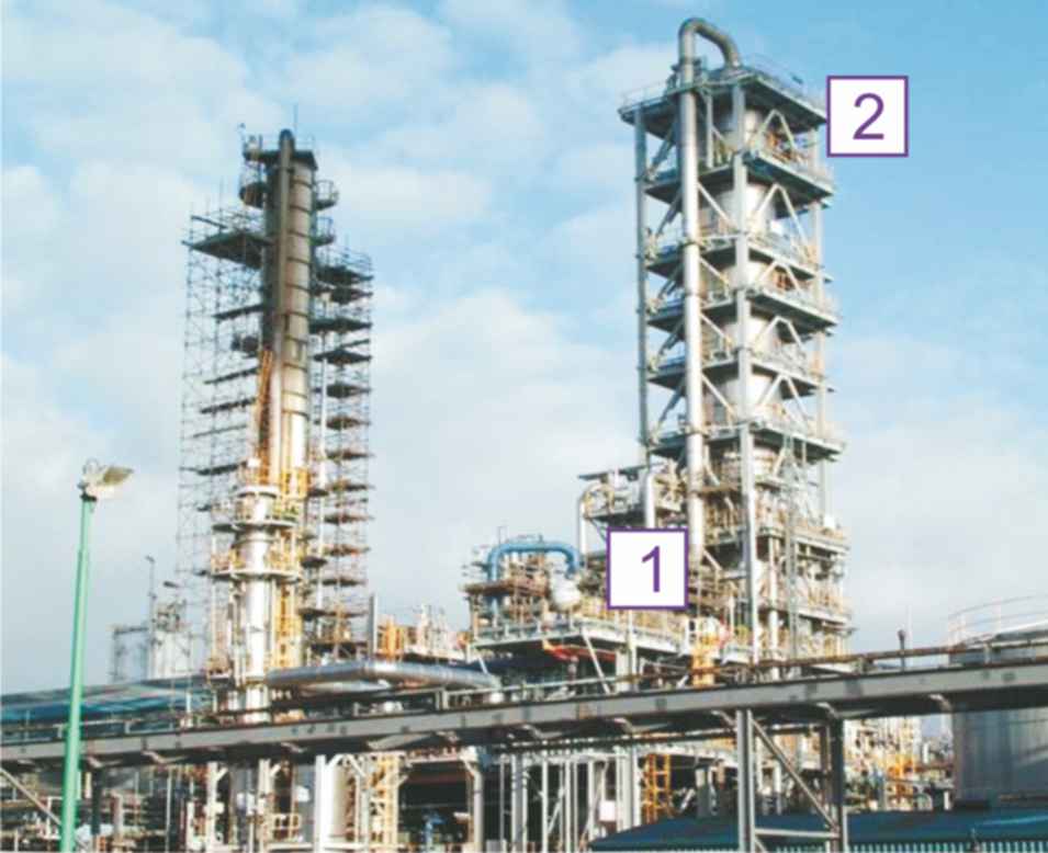 A photograph of the plant manufacturing ethanoic acid using the Cativa process. The photograph shows the reactor, the distillation column to remove methanol, water and carbon monoxide.  Propionic acid is removed on further distillation