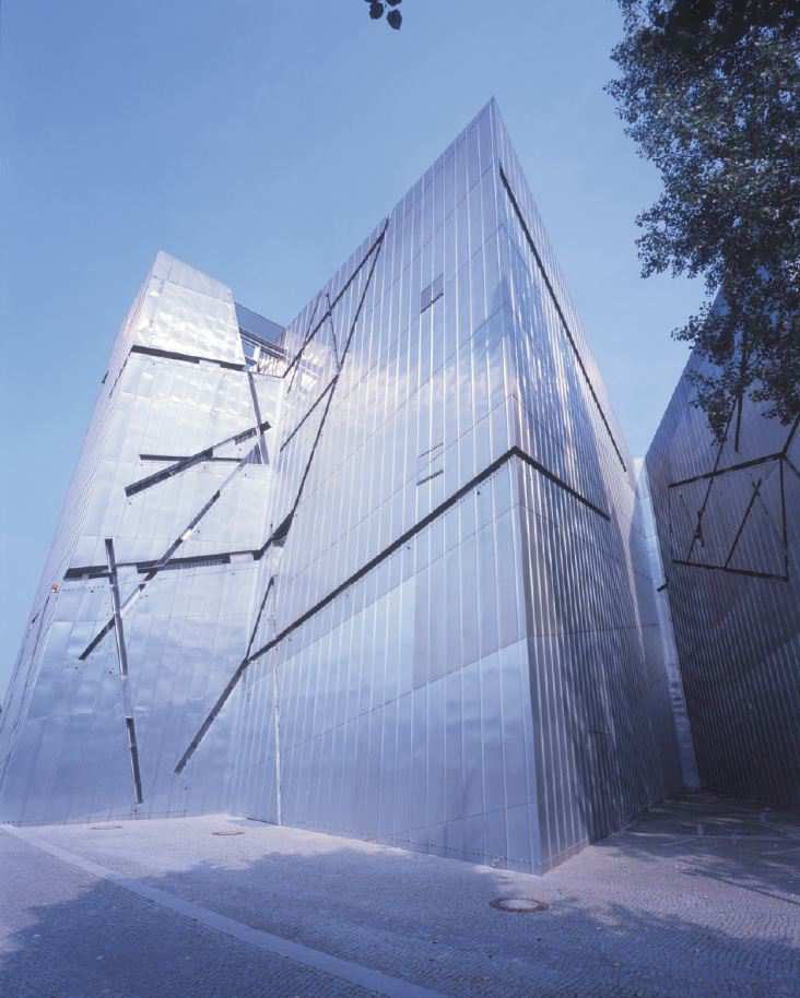 Photo of the museum, a shiny, smooth angular building pointing uptowards the sky