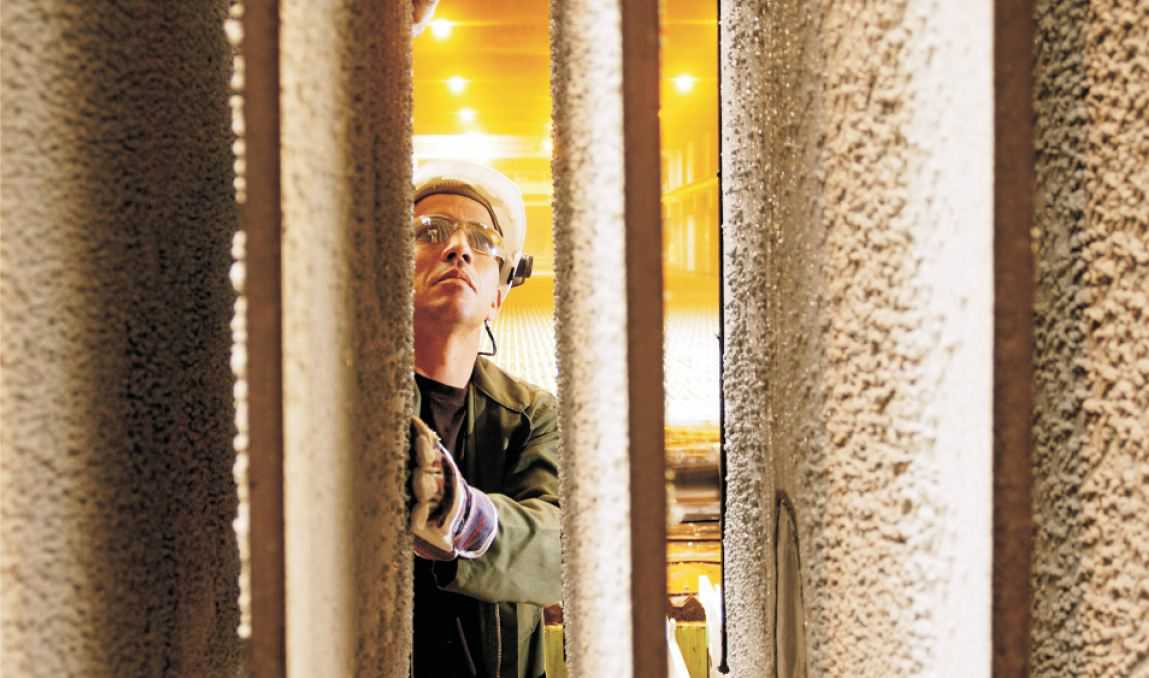 Photo of a worker standing next to the cathodes